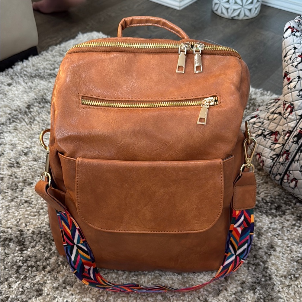 Tan Leather Backpack with Flag-Inspired Strap